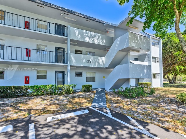 8401 Lagos De Campo Blvd Unit 210V, Tamarac, FL 33321 - view of building exterior featuring uncovered parking and stairway