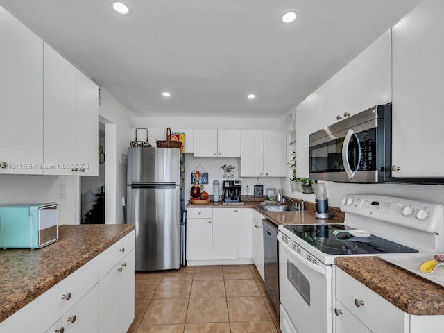 8401 Lagos De Campo Blvd Unit 210V, Tamarac, FL 33321 - kitchen featuring appliances with stainless steel finishes, dark countertops, light tile patterned floors, a sink, and recessed lighting
