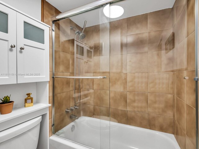 8401 Lagos De Campo Blvd Unit 210V, Tamarac, FL 33321 - bathroom featuring toilet and combined bath / shower with glass door