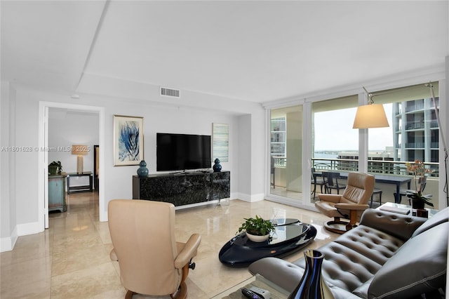 3400 SW 27th Ave Unit 1904, Coconut Grove, FL 33133 - living area with plenty of natural light, baseboards, and a wall of windows
