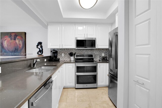 3400 SW 27th Ave Unit 1904, Coconut Grove, FL 33133 - kitchen with appliances with stainless steel finishes, a sink, a tray ceiling, and white cabinetry