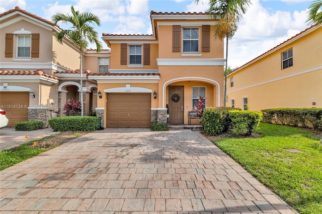 12441 Emerald Creek Mnr, Plantation, FL 33325 - multi unit property featuring stucco siding, an attached garage, decorative driveway, a tiled roof, and stone siding