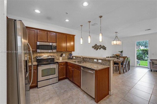 12441 Emerald Creek Mnr, Plantation, FL 33325 - kitchen with stainless steel appliances, a sink, brown cabinetry, a peninsula, and recessed lighting