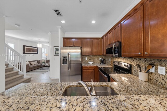12441 Emerald Creek Mnr, Plantation, FL 33325 - kitchen with stainless steel appliances, a sink, light stone counters, decorative backsplash, and crown molding