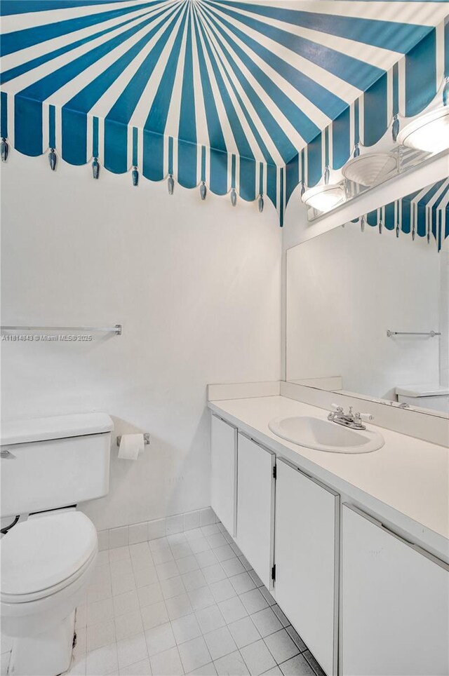 2591 Trapp Ave Unit 4, Miami, FL 33133 - bathroom with vanity, toilet, and tile patterned flooring