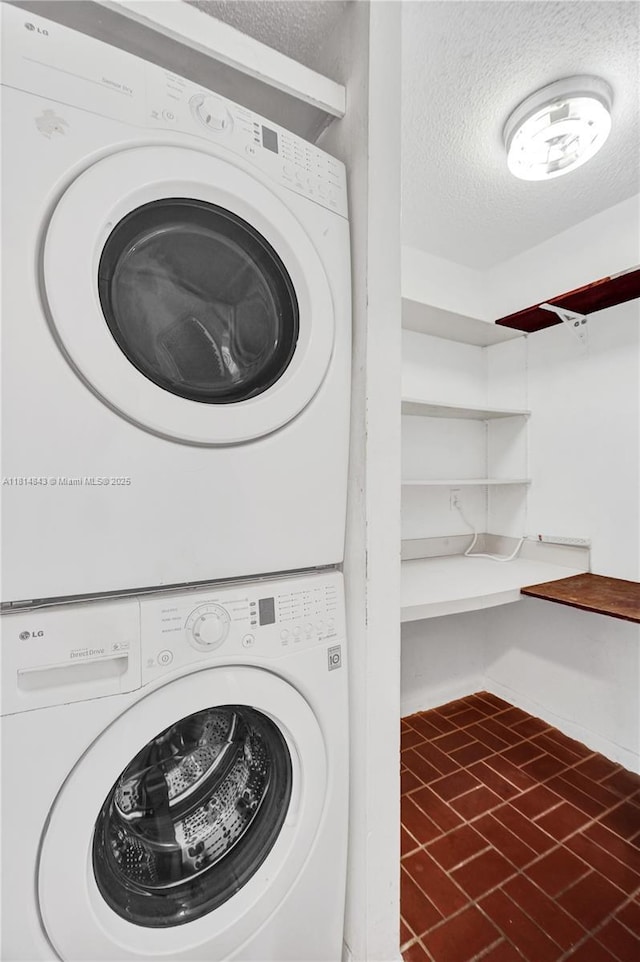 2591 Trapp Ave Unit 4, Miami, FL 33133 - washroom featuring estacked washer and dryer and a textured ceiling