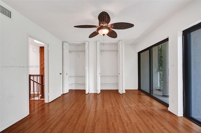 2591 Trapp Ave Unit 4, Miami, FL 33133 - unfurnished bedroom featuring light wood finished floors, two closets, and baseboards