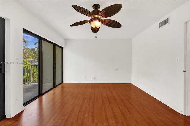 2591 Trapp Ave Unit 4, Miami, FL 33133 - empty room with wood finished floors, a ceiling fan, a textured ceiling, and baseboards