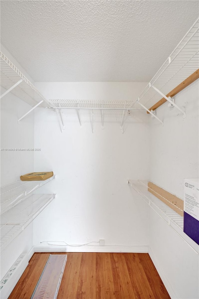 2591 Trapp Ave Unit 4, Miami, FL 33133 - walk in closet with wood finished floors