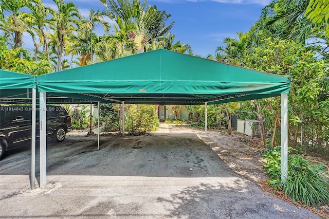2591 Trapp Ave Unit 4, Miami, FL 33133 - view of car parking with a detached carport