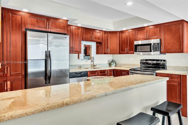 1410 S Ocean Dr Unit 502, Hollywood, FL 33019 - kitchen featuring appliances with stainless steel finishes, a sink, recessed lighting, light stone counters, and a breakfast bar area