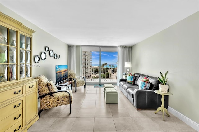 1410 S Ocean Dr Unit 502, Hollywood, FL 33019 - living area featuring a wall of windows, light tile patterned floors, and baseboards