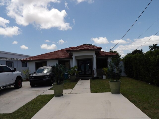 12210 SW 216th St, Miami, FL 33170 - mediterranean / spanish house featuring a tiled roof, stucco siding, and a front yard