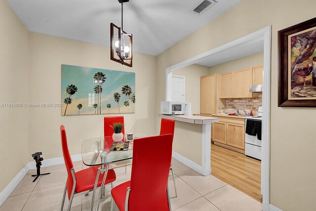 435 NW 44th Ave, Miami, FL 33126 - dining room featuring light tile patterned floors and baseboards