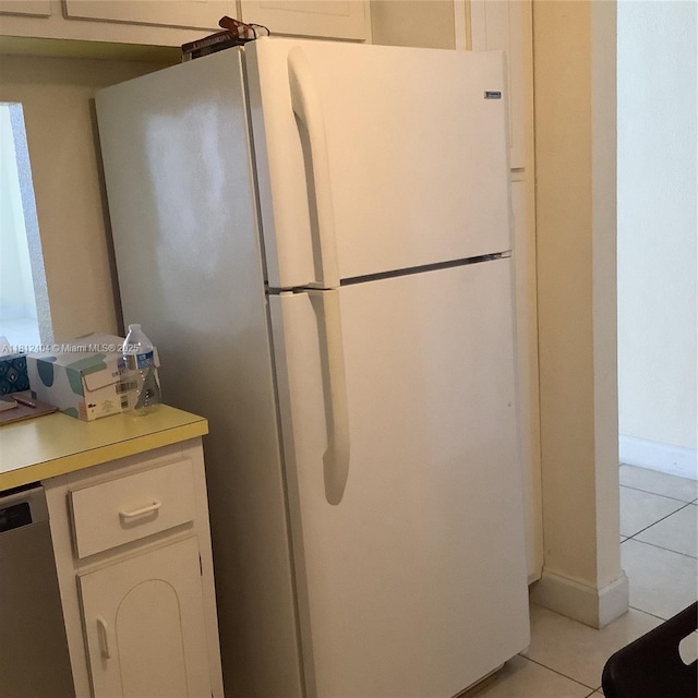 1865 S Ocean Dr Unit 10D, Hallandale Beach, FL 33009 - kitchen with freestanding refrigerator, dishwasher, light tile patterned floors, light countertops, and white cabinets