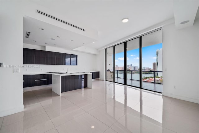 3250 NE 188th St Unit Lph07, Aventura, FL 33180 - kitchen with modern cabinets, light countertops, a wall of windows, a center island with sink, and a view of city