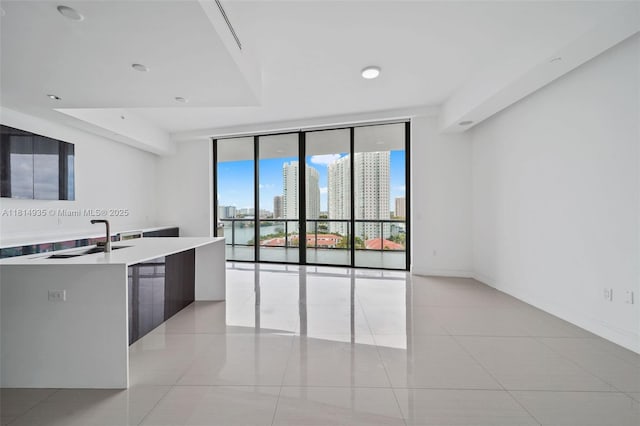 3250 NE 188th St Unit Lph07, Aventura, FL 33180 - kitchen with a sink, modern cabinets, light countertops, light tile patterned flooring, and expansive windows