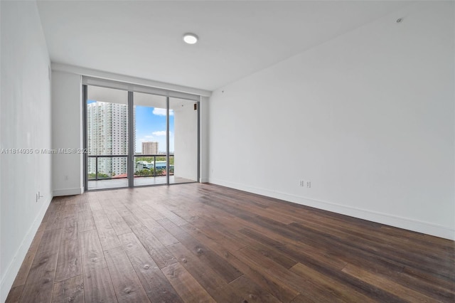 3250 NE 188th St Unit Lph07, Aventura, FL 33180 - spare room with dark wood-style floors, expansive windows, baseboards, and a city view