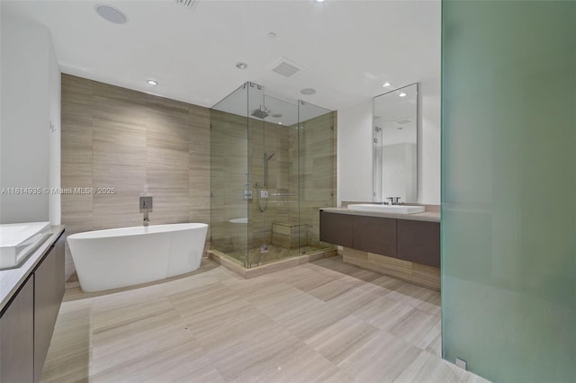 3250 NE 188th St Unit Lph07, Aventura, FL 33180 - full bath featuring a stall shower, vanity, a freestanding bath, and tile walls