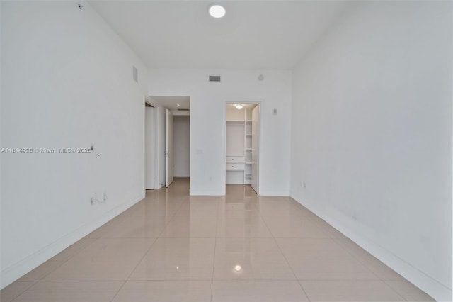 3250 NE 188th St Unit Lph07, Aventura, FL 33180 - unfurnished bedroom featuring light tile patterned floors, baseboards, a walk in closet, and recessed lighting