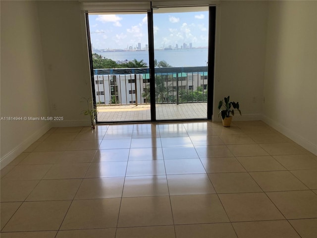 2333 Brickell Ave Unit 615, Miami, FL 33129 - unfurnished room featuring healthy amount of natural light, baseboards, tile patterned flooring, and a view of city