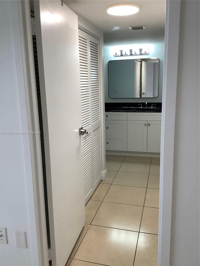 2333 Brickell Ave Unit 615, Miami, FL 33129 - corridor with light tile patterned floors and a sink