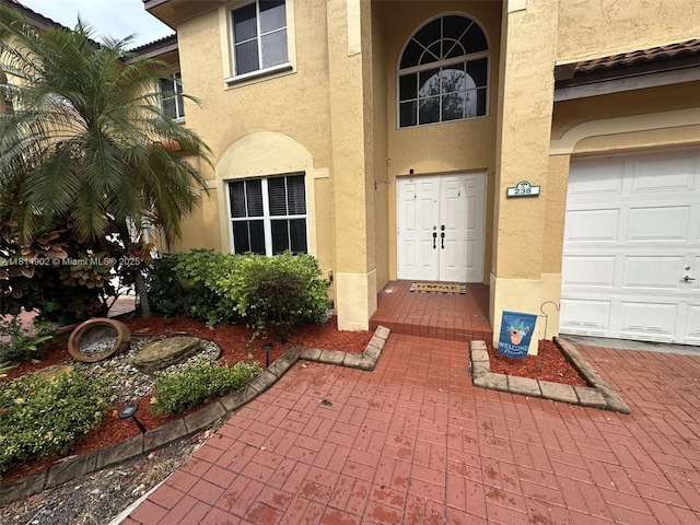 238 Magnolia Ave, Davie, FL 33325 - doorway to property featuring stucco siding and a garage