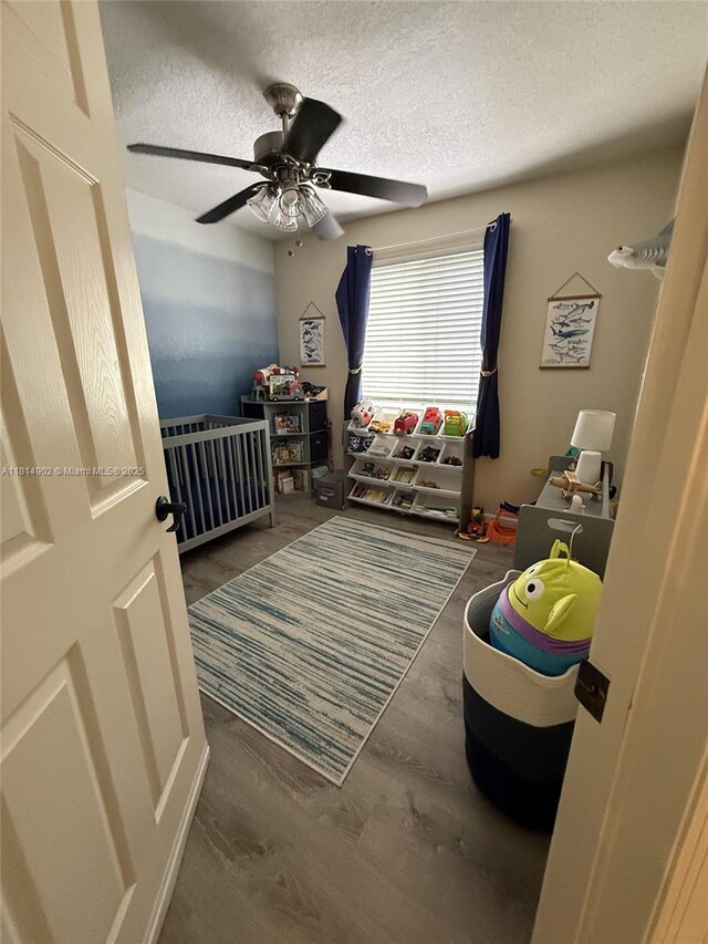 238 Magnolia Ave, Davie, FL 33325 - bedroom featuring a textured ceiling, wood finished floors, and ceiling fan