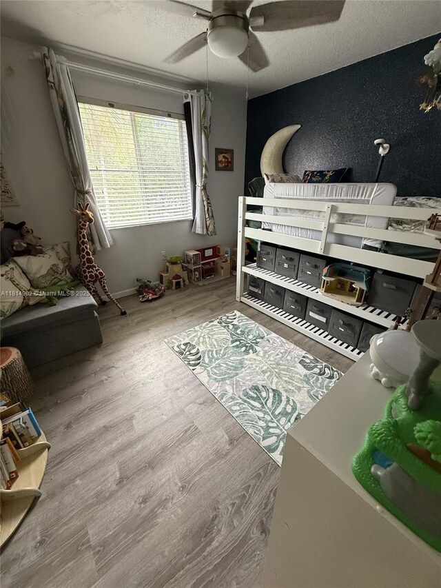 238 Magnolia Ave, Davie, FL 33325 - bedroom featuring wood finished floors, ceiling fan, and a textured ceiling