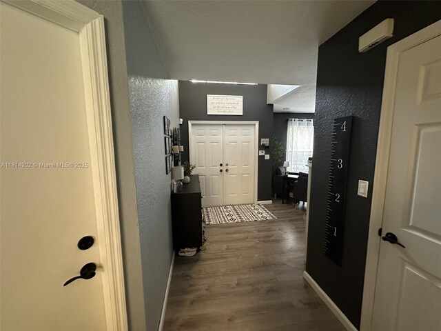 238 Magnolia Ave, Davie, FL 33325 - foyer entrance featuring wood finished floors, baseboards, and a textured wall