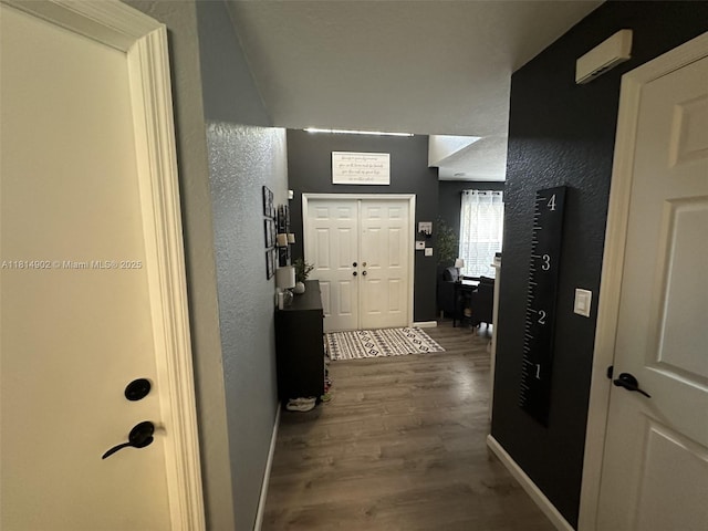 238 Magnolia Ave, Davie, FL 33325 - entrance foyer featuring wood finished floors, baseboards, and a textured wall