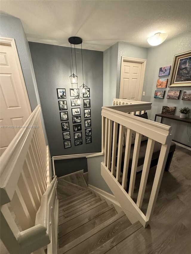 238 Magnolia Ave, Davie, FL 33325 - stairs featuring wood finished floors, baseboards, and a textured ceiling