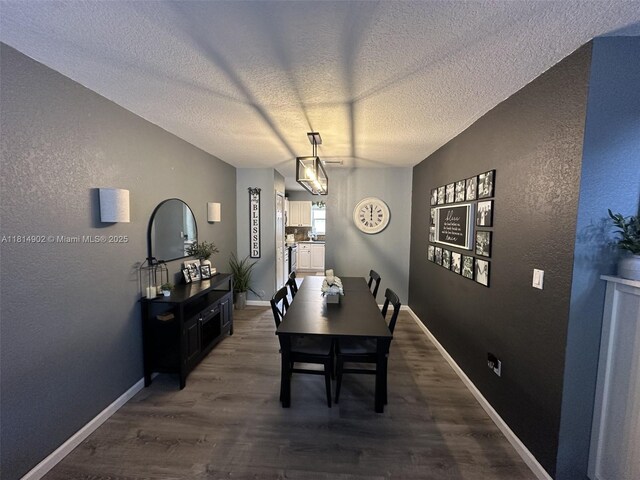 238 Magnolia Ave, Davie, FL 33325 - dining room featuring a textured wall, dark wood finished floors, a textured ceiling, and baseboards