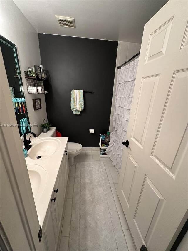 238 Magnolia Ave, Davie, FL 33325 - bathroom with double vanity, toilet, a shower with shower curtain, and tile patterned flooring