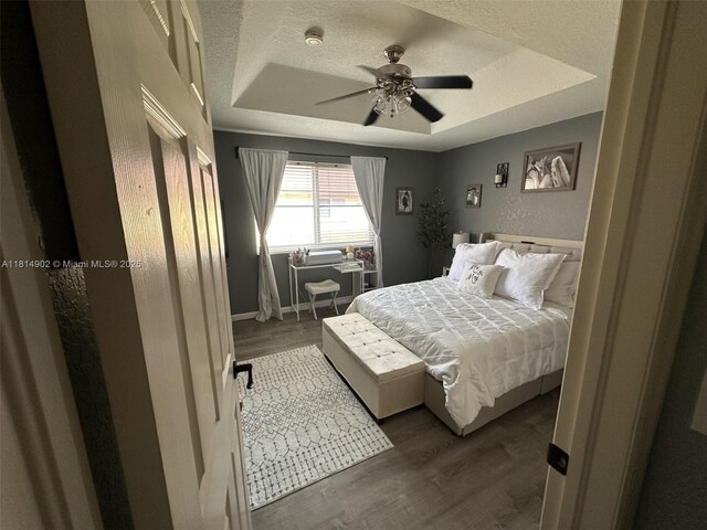238 Magnolia Ave, Davie, FL 33325 - bedroom featuring a raised ceiling, wood finished floors, and a ceiling fan