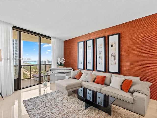 16275 Collins Ave Unit 2103, Sunny Isles Beach, FL 33160 - living room featuring expansive windows, light tile patterned floors, and a textured ceiling