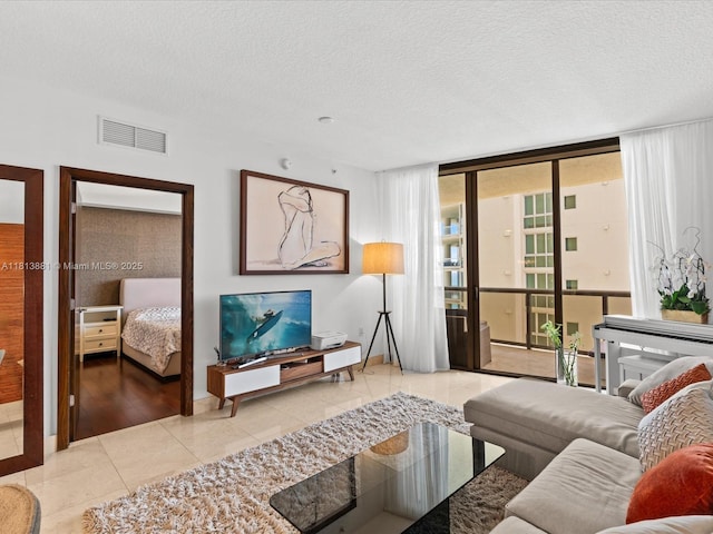 16275 Collins Ave Unit 2103, Sunny Isles Beach, FL 33160 - living room with a wall of windows, a textured ceiling, and light tile patterned floors