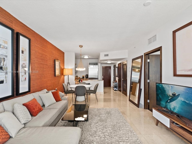 16275 Collins Ave Unit 2103, Sunny Isles Beach, FL 33160 - living room featuring an accent wall and wallpapered walls