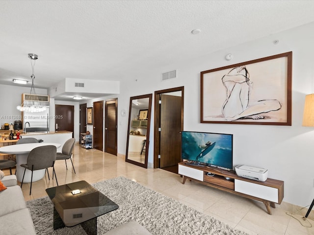 16275 Collins Ave Unit 2103, Sunny Isles Beach, FL 33160 - living room with light tile patterned floors and a textured ceiling