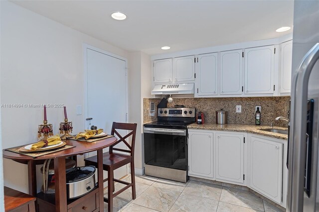 3015 N Ocean Blvd Unit 7D, Fort Lauderdale, FL 33308 - kitchen with stainless steel appliances, extractor fan, a sink, tasteful backsplash, and white cabinetry