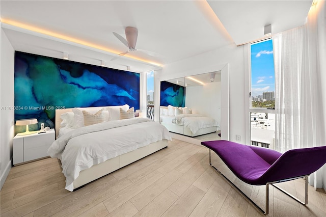 1500 Ocean Dr Unit 910, Miami Beach, FL 33139 - bedroom featuring expansive windows, light wood finished floors, and ceiling fan