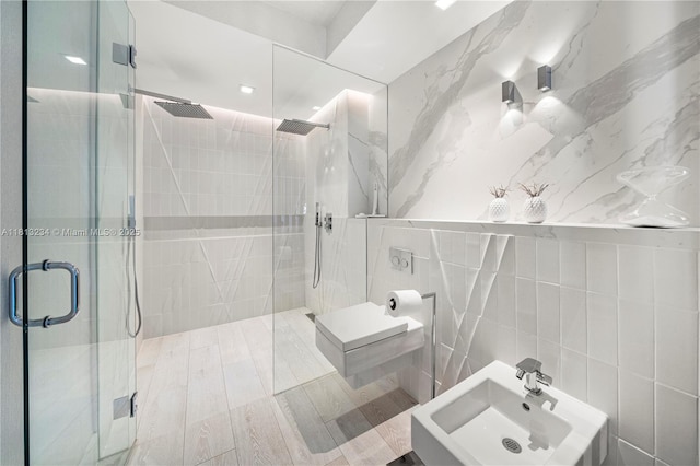 1500 Ocean Dr Unit 910, Miami Beach, FL 33139 - bathroom with tile walls, a stall shower, a sink, and a bidet