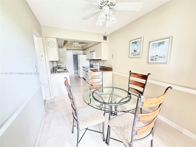1470 Sheridan St Unit 18C, Hollywood, FL 33020 - dining space with a ceiling fan, light tile patterned floors, and baseboards