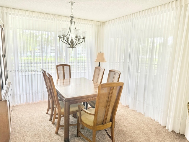 1470 Sheridan St Unit 18C, Hollywood, FL 33020 - dining area featuring a chandelier, carpet flooring, and a textured ceiling