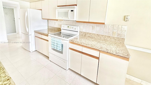 1470 Sheridan St Unit 18C, Hollywood, FL 33020 - kitchen featuring white appliances, light countertops, tasteful backsplash, and white cabinetry