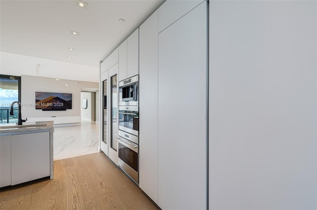 2200 N Ocean Blvd Unit S1801, Fort Lauderdale, FL 33305 - kitchen with a sink, white cabinetry, modern cabinets, open floor plan, and recessed lighting