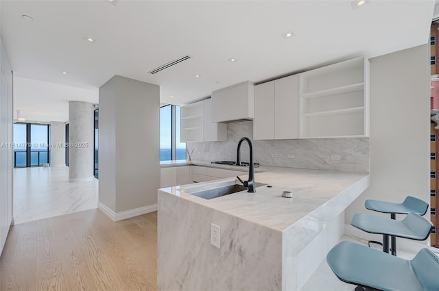 2200 N Ocean Blvd Unit S1801, Fort Lauderdale, FL 33305 - kitchen with open shelves, white cabinets, decorative backsplash, and recessed lighting