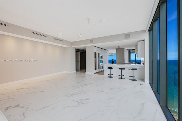2200 N Ocean Blvd Unit S1801, Fort Lauderdale, FL 33305 - unfurnished living room featuring light marble finish flooring and baseboards