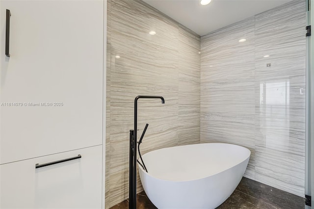 2200 N Ocean Blvd Unit S1801, Fort Lauderdale, FL 33305 - bathroom with tile walls, a freestanding bath, and recessed lighting