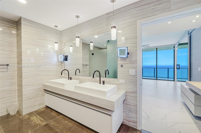 2200 N Ocean Blvd Unit S1801, Fort Lauderdale, FL 33305 - bathroom with tile walls, double vanity, and marble finish floors